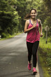 © torwaiphoto - Asian woman were jogging on the road In the forest with sunny