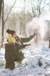© goodmoments - Happy family having fun with snow in the park on a sunny day. Mother with cute toddler child enjoying winter outdoors. Mom with boy. Winter and holidays seasons concept.
