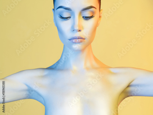 Fotografia Elegant model in the light colored spotlights