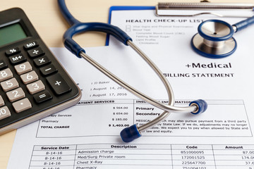 Medical cost concept with calculator and stethoscope