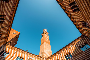 Wall Mural - Ragione palace with Lamberti tower in the center of Verona old town in Italy. Geometrical view from below with copy space