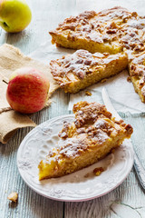 Wall Mural - Homemade apple and almond cake. Piece of pie on white plate and fresh fruits on wooden background