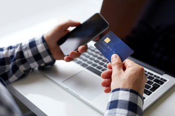 Wall Mural - man with credit card and mobile phone