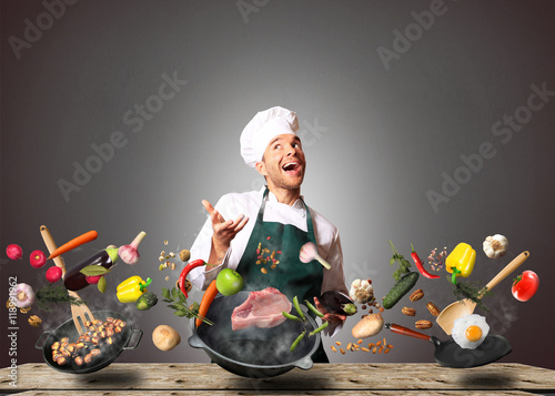 Fotografie, Obraz Chef juggling with vegetables and other food in the kitchen