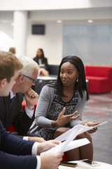 Wall Mural - Businesspeople Discuss Document In Lobby Of Modern Office