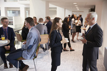 Delegates Networking During Coffee Break At Conference