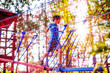 © EvgeniiAnd - children's safety on playground. boy plays in the playground shielded with a protective safety net. blurred background, blurred motion due to the concept