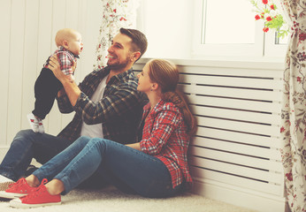 happy family mother and father playing with a baby