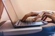 © fifeflyingfife - Female hands working on modern laptop early in the morning, Woman working on new project while flying at airplane, blurred background, shallow DOF.