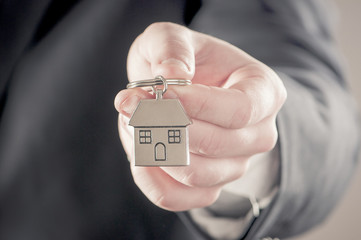 Real estate agent handing over house keys 