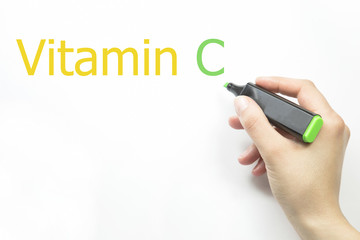 Hand writing vitamin c with green marker on transparent wipe board