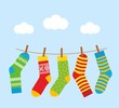 colorful bright socks on a rope with clothespins against a background of sky and clouds. Cute clothes. Cartoon summer illustration.