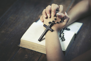 Wall Mural - Praying woman holds  cross