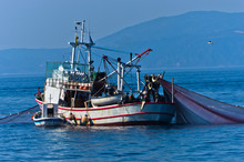 Fishing Boat With Nests At Sea In Front Of Mountain Athos, Greece