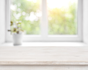 Wall Mural - wooden table on defocused summer window with flower pot background