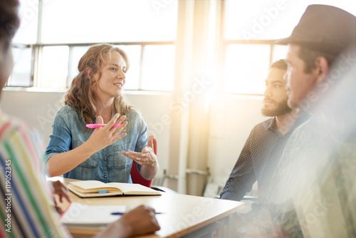 Fotografia Unposed group of creative business people in an open concept office brainstorming their next project