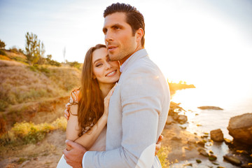 Canvas Print - Attractive bride and groom getting married by the beach