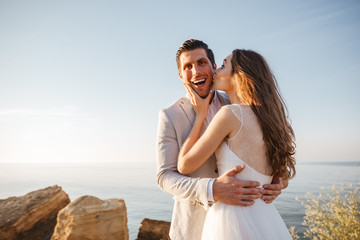 Canvas Print - Happy just married young wedding couple celebrating