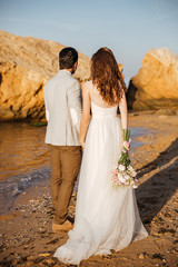 Canvas Print - Back view of a romantic happy married couple standing