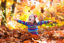Little Girl In Autumn Park