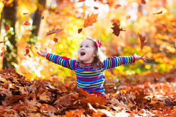 Little girl in autumn park