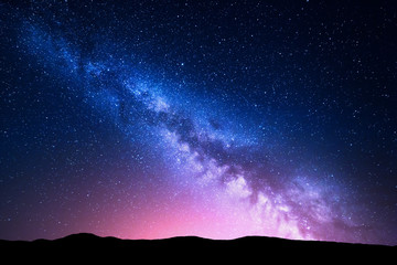 Wall Mural - milky way and pink light at mountains. night colorful landscape.