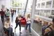 © Monkey Business - Students walk and talk using mobile devices in university