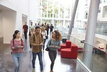 Students Walk And Talk Using Mobile Devices In University