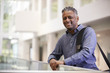 © Monkey Business - Middle aged black man  smiling in modern building lobby