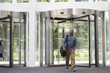 © Monkey Business - Middle aged black man entering the foyer of modern building