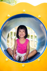 Wall Mural - Asian Chinese little girl sitting at playground