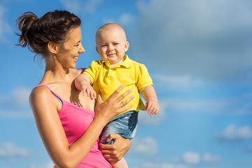 woman with a child playing on the beach