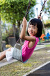 Leinwandbild Motiv Asian Chinese little girl on swing in playground