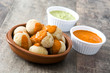 Canarian potatoes (papas arrugadas) with mojo sauce on wooden table

