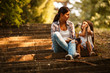 © BalanceFormCreative - Mother and daughter relaxing in park.She reading a fairytale to her daughter