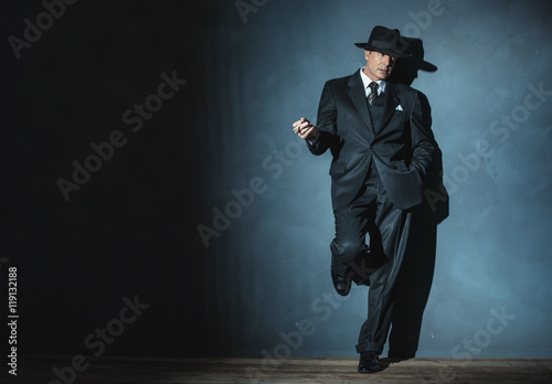 Poster Retro 1940 film noir gangster wearing suit and hat. Smoking ciga