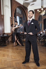 Wall Mural - Confident Man Standing While Dancers Performing Tango