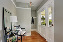 Entryway With Gray Walls, Console Table And Wood Floors