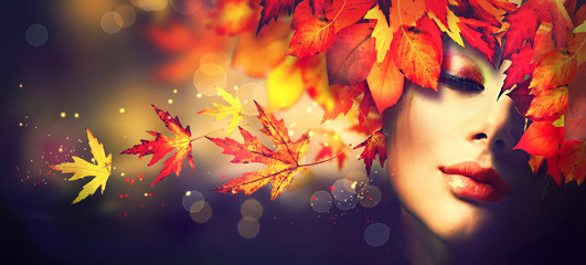 Wall Mural - Fall. Beauty model girl with colourful autumn leaves hairstyle