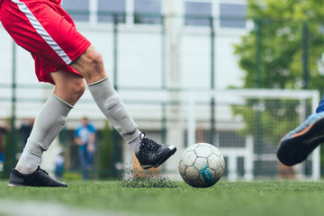 Futsal / Football / Soccer. A player hits the ball on the artificial turf