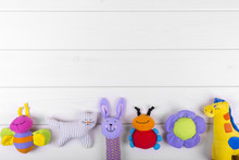 Stuffed Baby Toys On Wooden Background With Copy Space