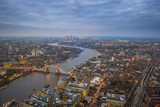 Fototapeta Londyn - London, England - Aerial Skyline view of London with the iconic Tower Bridge, Tower of London and skyscrapers of Canary Wharf at dusk