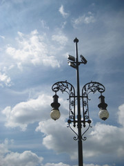 Historic old black and white outside street lantern against blue sky and clouds nature background