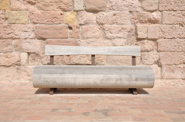 Wall Mural - Wooden bench against a stone wall