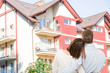 © REDPIXEL - Young couple looking at dream house.