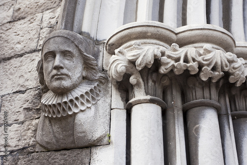 Stampa su Tela Statue of Arlechinno on a building in Dublin