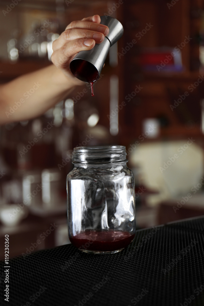Woman hands making cocktail on bar counter