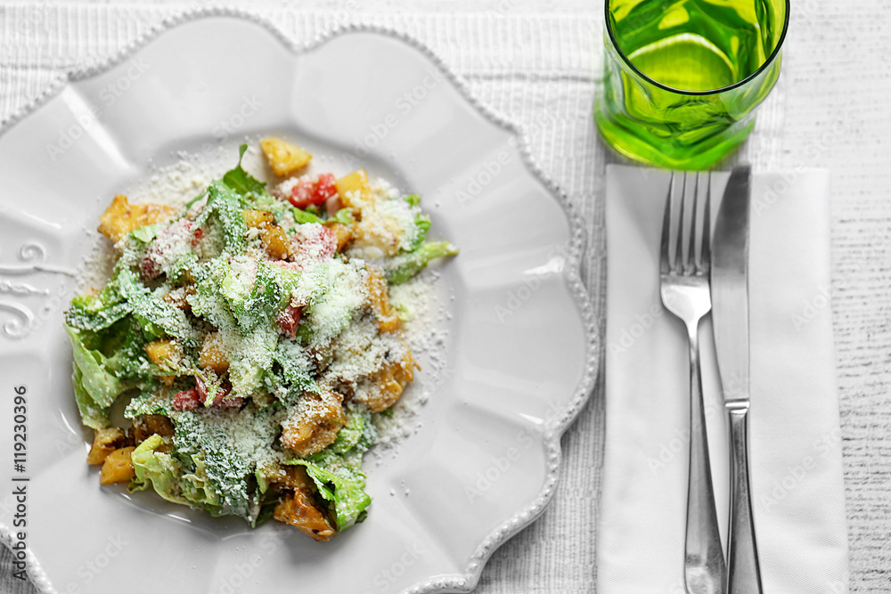 Tasty salad on white wooden table in cafe