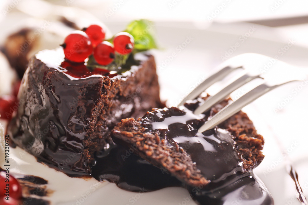 Tasty chocolate fondant cake with red currant, closeup