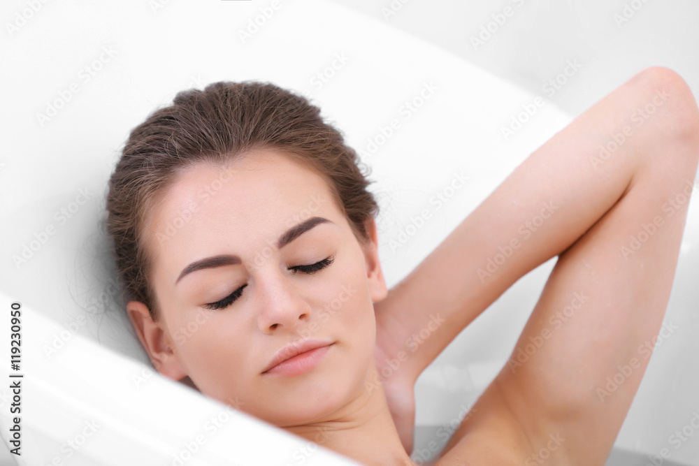 Beautiful girl relaxing in bathtub